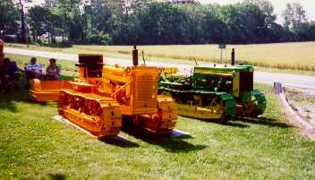 This is a picture of a orange 420C with grill guard at a show in Waterloo